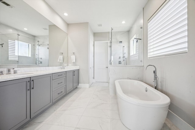 308 Willard, Houston, TX 77006 - full bath featuring a marble finish shower, double vanity, marble look tiles, a freestanding bath, and baseboards