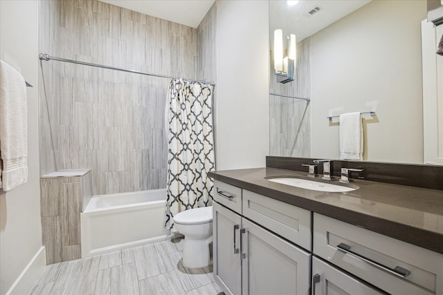 full bathroom featuring toilet, shower / tub combo, vanity, and visible vents