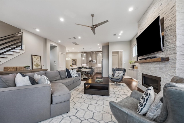 308 Willard, Houston, TX 77006 - living area featuring stairway, ceiling fan, a stone fireplace, light wood finished floors, and recessed lighting