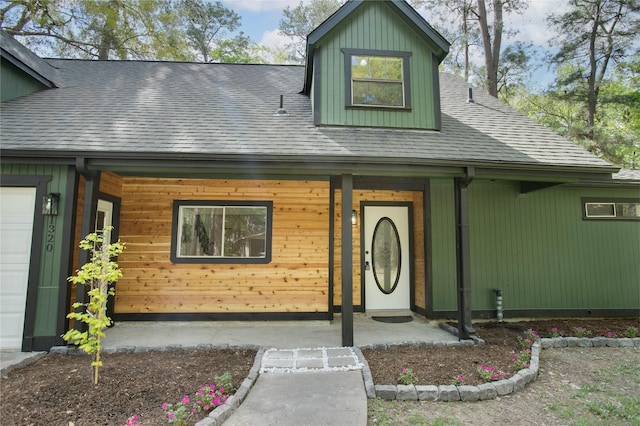 view of front of home featuring covered porch and a shingled roof