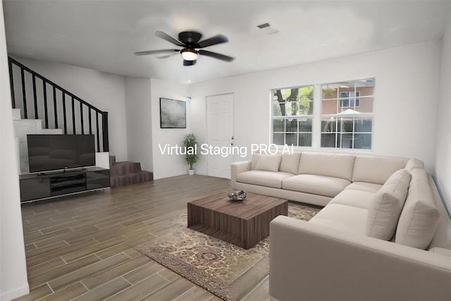 living area with stairs, a ceiling fan, visible vents, and wood finished floors
