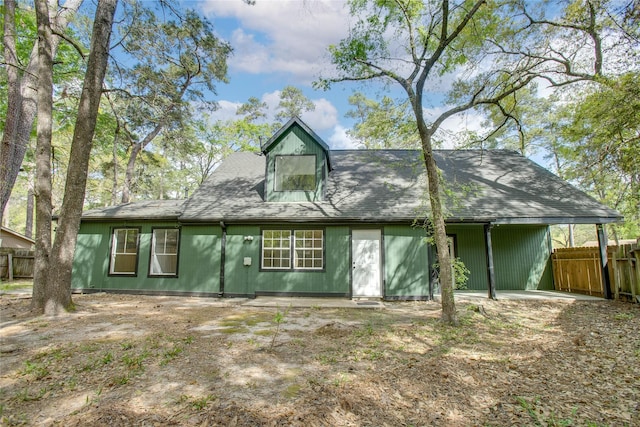 back of property featuring fence