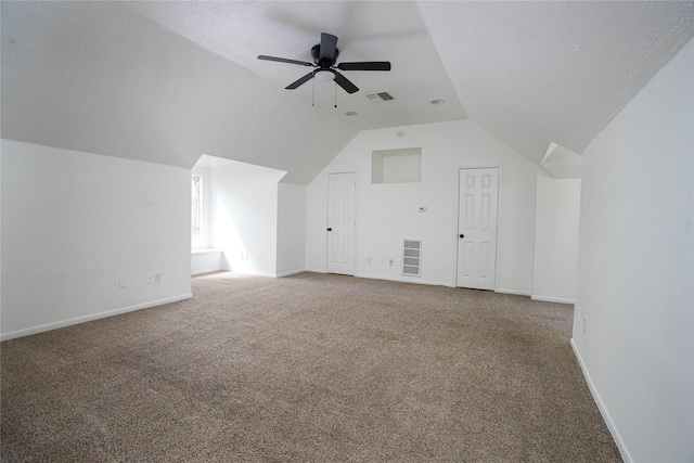 additional living space featuring carpet flooring, vaulted ceiling, and visible vents
