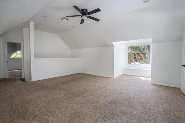 bonus room featuring a ceiling fan, vaulted ceiling, visible vents, and carpet floors