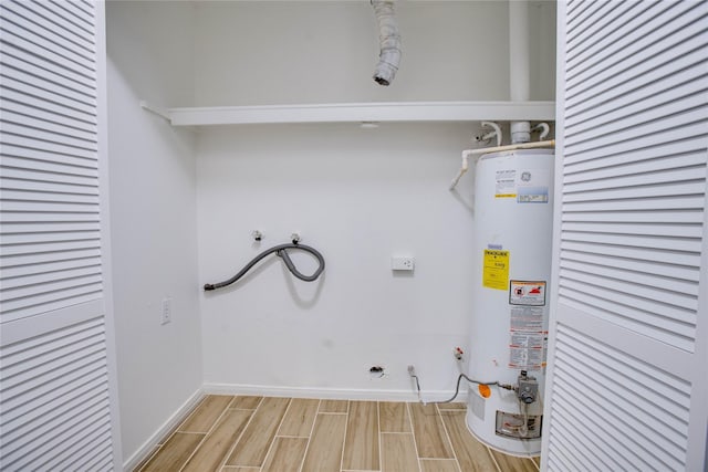 laundry room with laundry area, hookup for a washing machine, water heater, light wood-type flooring, and baseboards