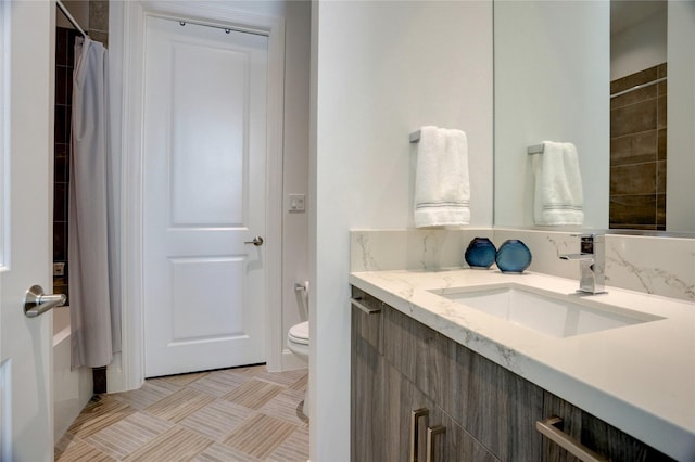 bathroom featuring vanity and toilet