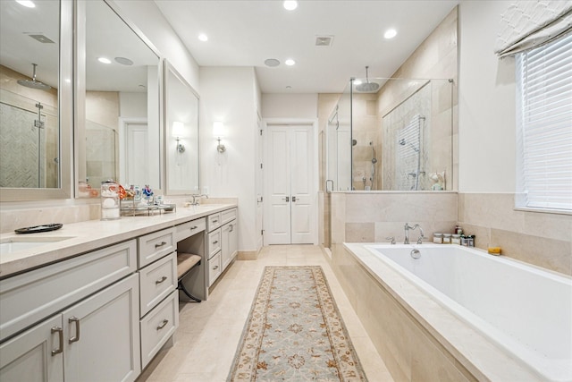 823 Blackshire Ln, Houston, TX 77055 - full bathroom with tile patterned floors, recessed lighting, a shower stall, double vanity, and a garden tub