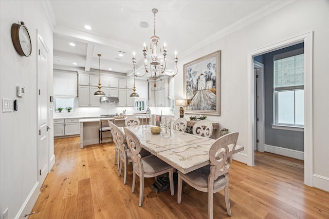 dining space with an inviting chandelier, light wood-style flooring, and crown molding