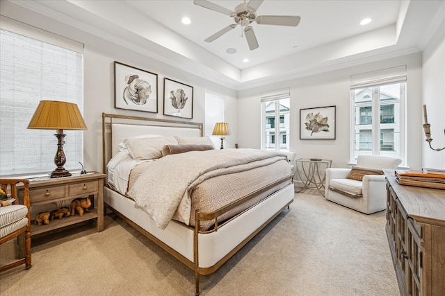 bedroom with a ceiling fan, a tray ceiling, recessed lighting, and light colored carpet