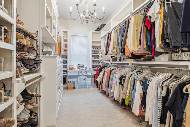 walk in closet featuring carpet flooring and a notable chandelier