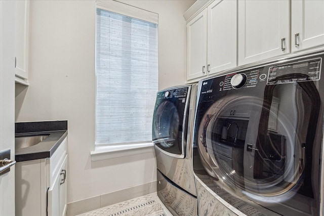 823 Blackshire Ln, Houston, TX 77055 - laundry room featuring washer and clothes dryer, a sink, cabinet space, and baseboards