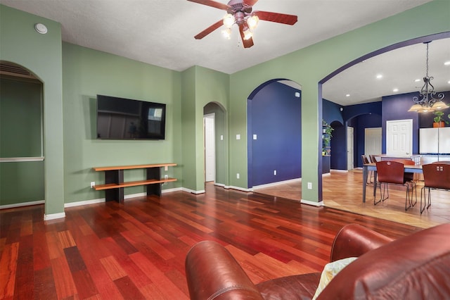 4407 Iron Creek Ct, Fresno, TX 77545 - living room featuring wood finished floors, a ceiling fan, arched walkways, a chandelier, and recessed lighting