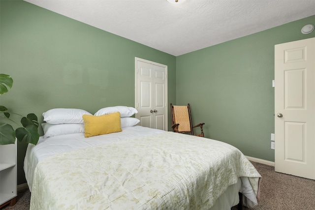 4407 Iron Creek Ct, Fresno, TX 77545 - carpeted bedroom featuring a closet, baseboards, and a textured ceiling