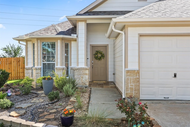 4407 Iron Creek Ct, Fresno, TX 77545 - view of exterior entry with a garage, fence, and stone siding