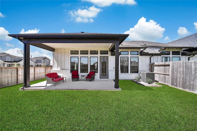 rear view of property with central air condition unit, a patio area, a yard, a fenced backyard, and board and batten siding
