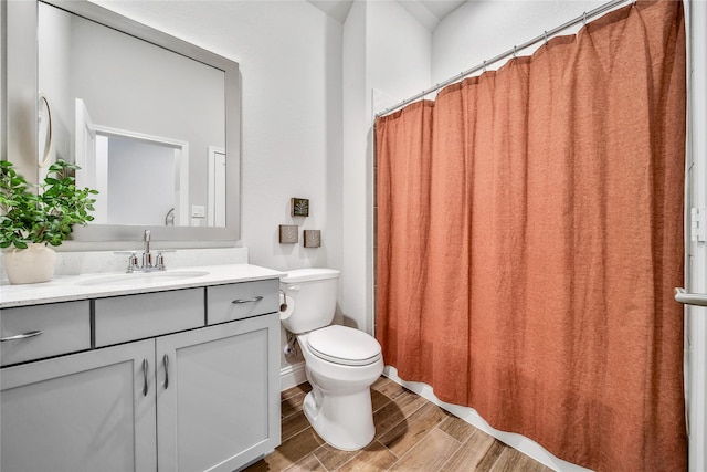 full bathroom with toilet, wood finished floors, and vanity