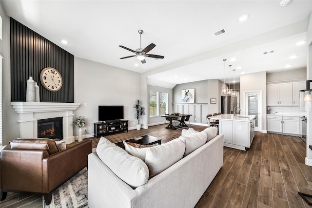 living area featuring a ceiling fan, dark wood-style floors, and visible vents