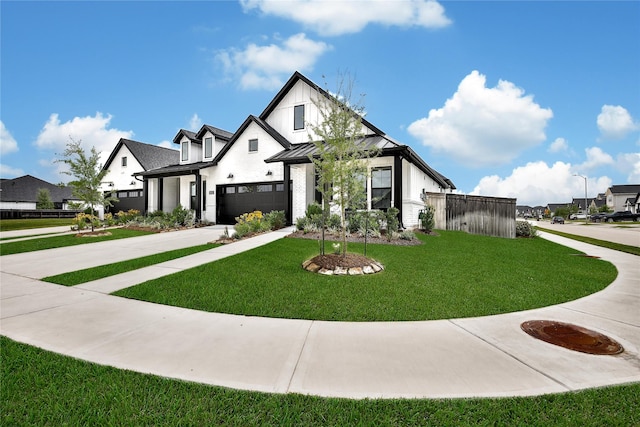 modern farmhouse featuring a standing seam roof, metal roof, a garage, concrete driveway, and a front lawn