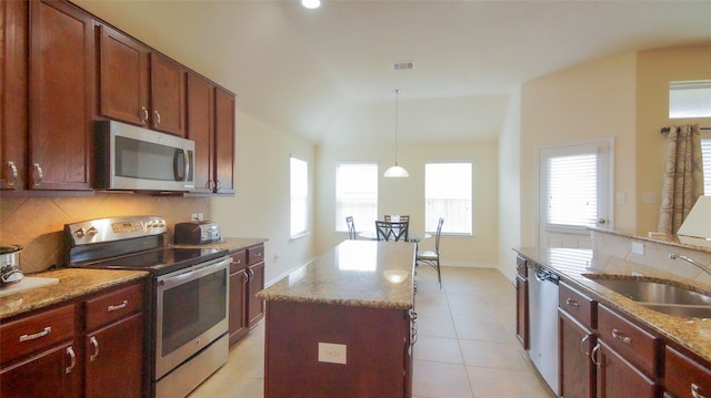 15407 Vincennes Oak St, Cypress, TX 77429 - kitchen with a sink, stainless steel appliances, visible vents, decorative backsplash, and a center island