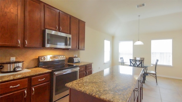 15407 Vincennes Oak St, Cypress, TX 77429 - kitchen featuring stainless steel appliances, decorative light fixtures, visible vents, vaulted ceiling, and backsplash