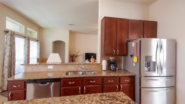 15407 Vincennes Oak St, Cypress, TX 77429 - kitchen featuring appliances with stainless steel finishes, decorative backsplash, light stone countertops, and a sink