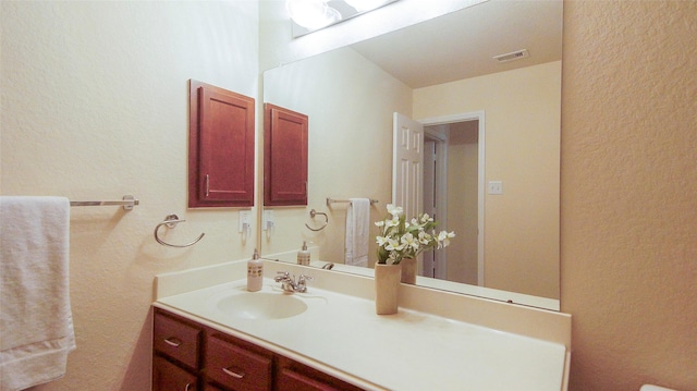 15407 Vincennes Oak St, Cypress, TX 77429 - bathroom with vanity, visible vents, and a textured wall