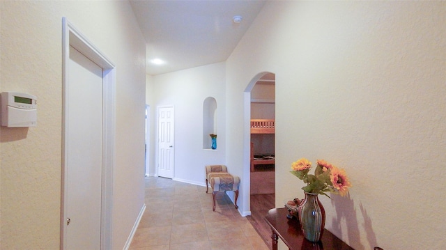 15407 Vincennes Oak St, Cypress, TX 77429 - hallway featuring arched walkways, light tile patterned floors, and recessed lighting
