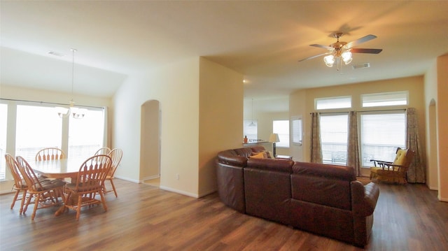 15407 Vincennes Oak St, Cypress, TX 77429 - living room featuring ceiling fan with notable chandelier, arched walkways, visible vents, and wood finished floors