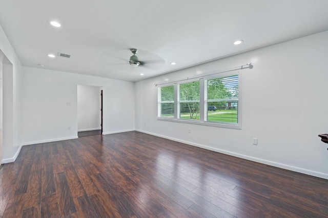 empty room featuring baseboards, visible vents, wood finished floors, and a ceiling fan
