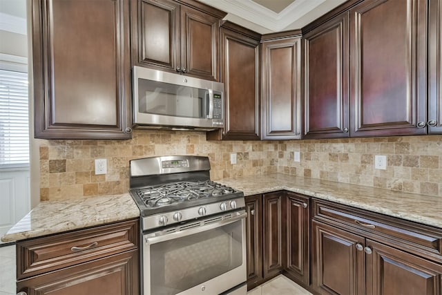 11002 Upland Forest Dr, Houston, TX 77043 - kitchen featuring dark brown cabinetry, stainless steel appliances, tasteful backsplash, and light stone counters