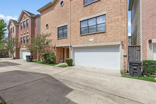 5817 Darling St Unit G, Houston, TX 77007 - view of property featuring concrete driveway and a garage