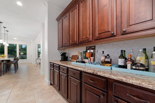 bar featuring recessed lighting, backsplash, light tile patterned floors, hanging light fixtures, and baseboards