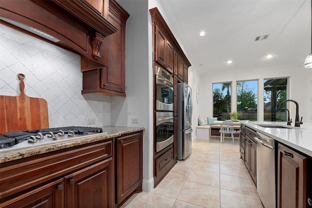 kitchen featuring recessed lighting, visible vents, a sink, decorative backsplash, and stainless steel appliances