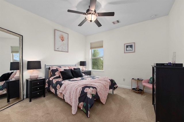 bedroom with light carpet, baseboards, visible vents, and ceiling fan