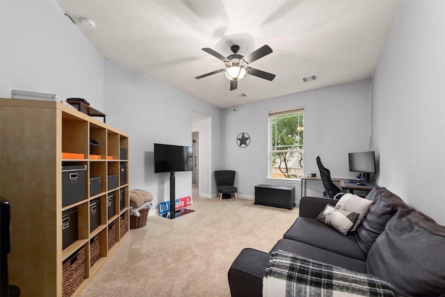 carpeted living room featuring a ceiling fan, baseboards, and visible vents