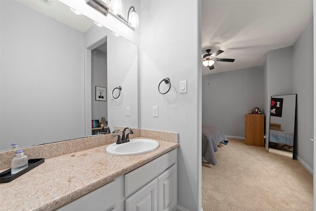 ensuite bathroom featuring baseboards, ensuite bathroom, vanity, and ceiling fan