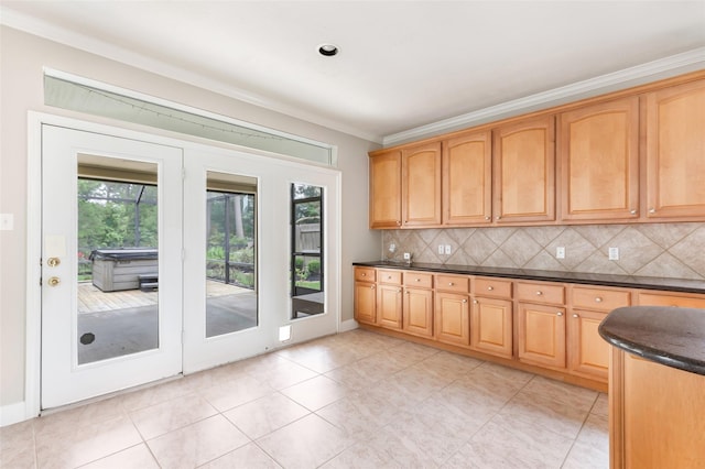 kitchen with ornamental molding, tasteful backsplash, light tile patterned flooring, and a healthy amount of sunlight
