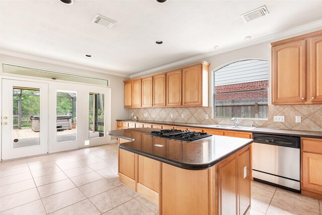 kitchen with a sink, gas cooktop, light brown cabinets, and dishwasher