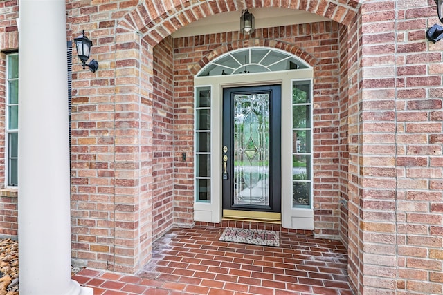 doorway to property with brick siding
