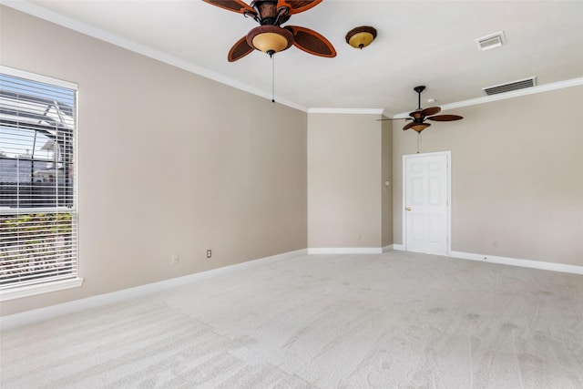 spare room with visible vents, ceiling fan, and light colored carpet