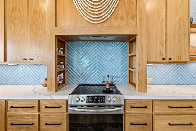 kitchen with light countertops, tasteful backsplash, light brown cabinets, and stainless steel electric stove