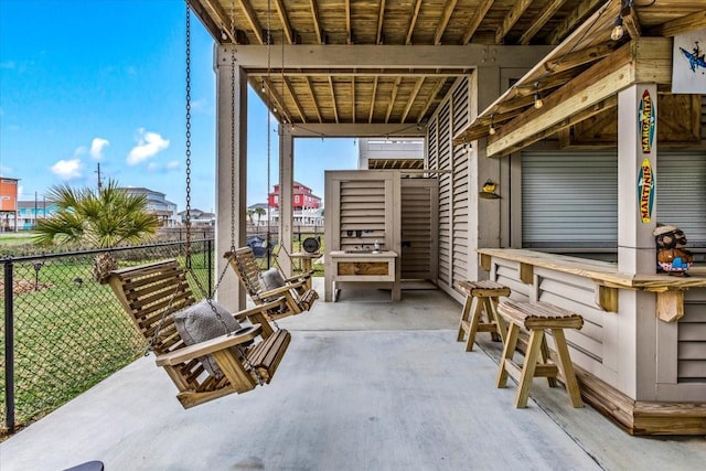 view of patio / terrace with fence and outdoor dry bar