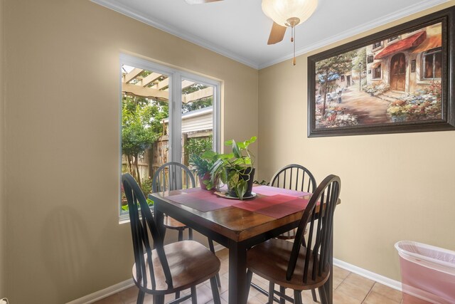 6180 Afton Ln, Beaumont, TX 77706 - dining space with light tile patterned floors, baseboards, a ceiling fan, and ornamental molding