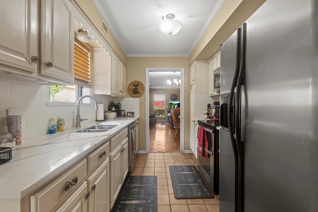 6180 Afton Ln, Beaumont, TX 77706 - kitchen featuring light tile patterned flooring, a sink, crown molding, backsplash, and stainless steel appliances