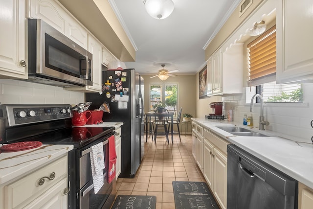 6180 Afton Ln, Beaumont, TX 77706 - kitchen featuring backsplash, appliances with stainless steel finishes, light tile patterned floors, and a sink