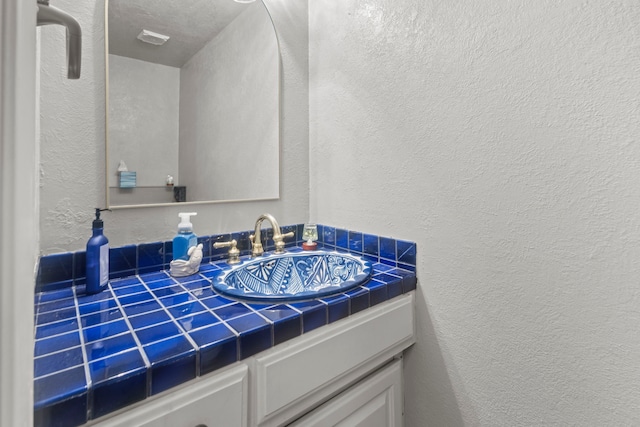 6180 Afton Ln, Beaumont, TX 77706 - bathroom featuring vanity and a textured wall