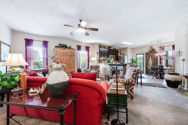 living area with carpet, ceiling fan, and plenty of natural light