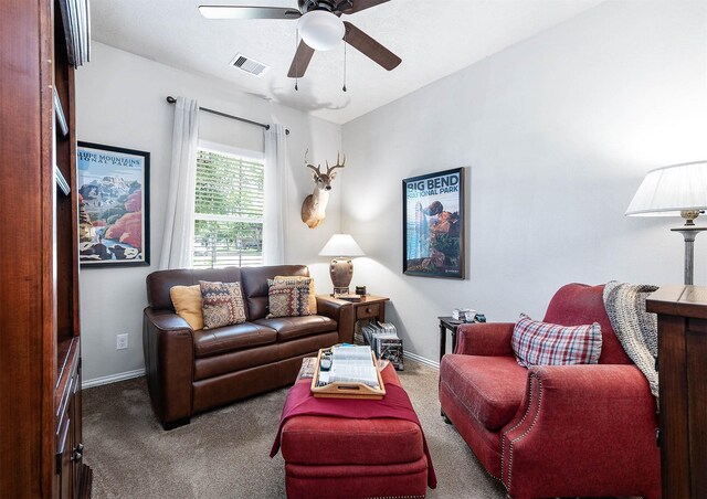 carpeted living area featuring visible vents, baseboards, and a ceiling fan