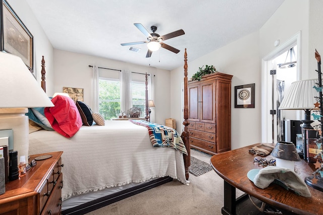 bedroom featuring visible vents, a ceiling fan, and light carpet