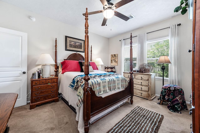 bedroom with carpet, a ceiling fan, and visible vents